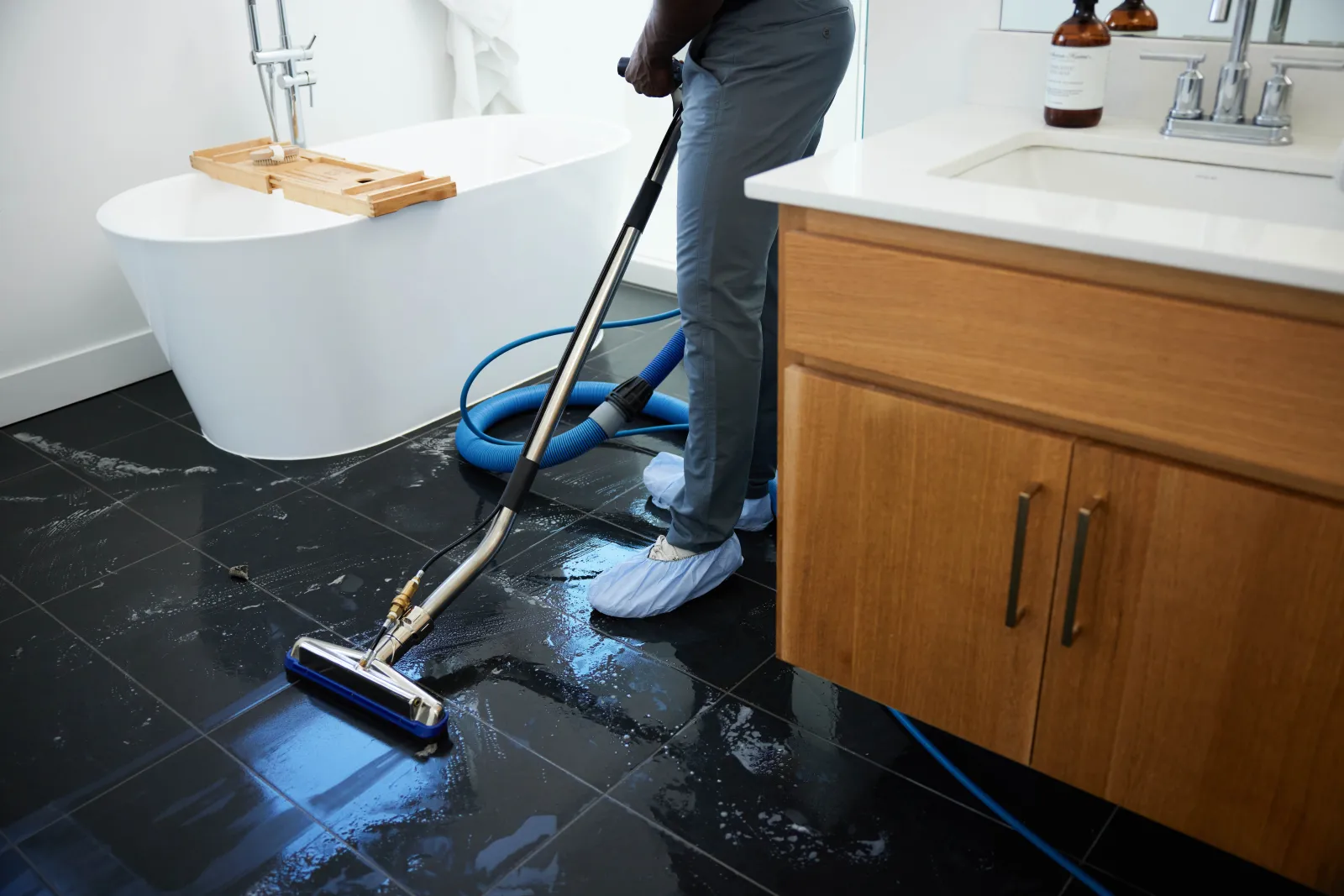 black bathroom tile being cleaned by Zerorez technician
