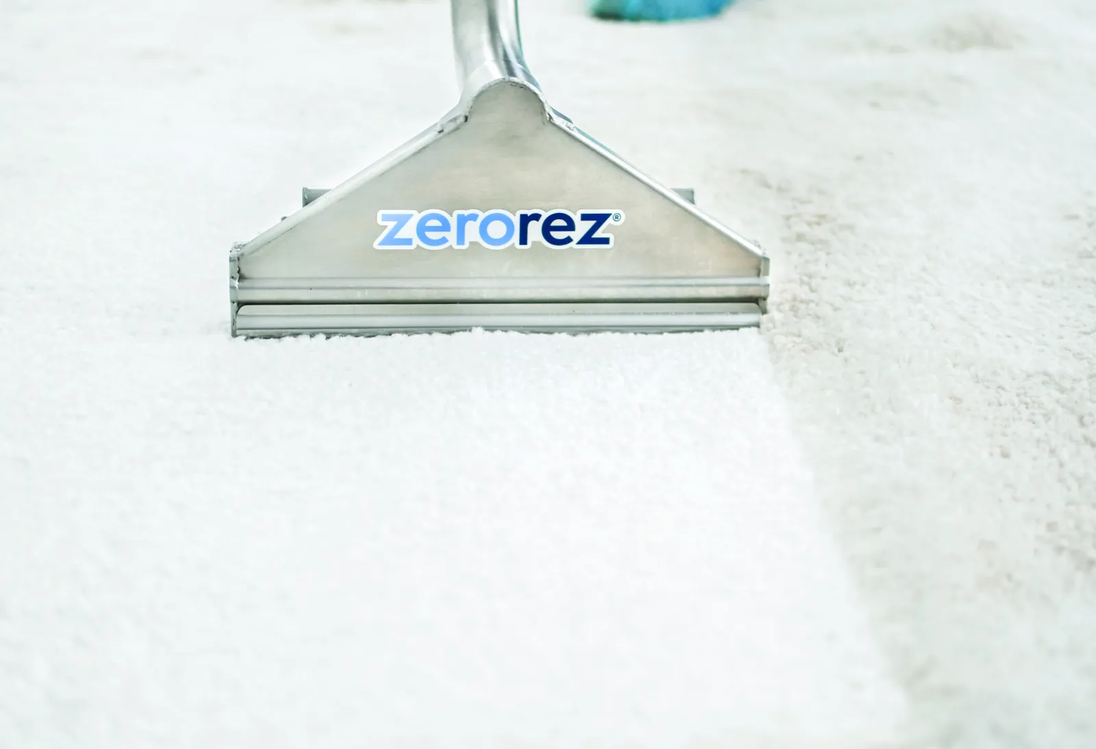 white stripe on white carpet with a vacuum cleaning wand